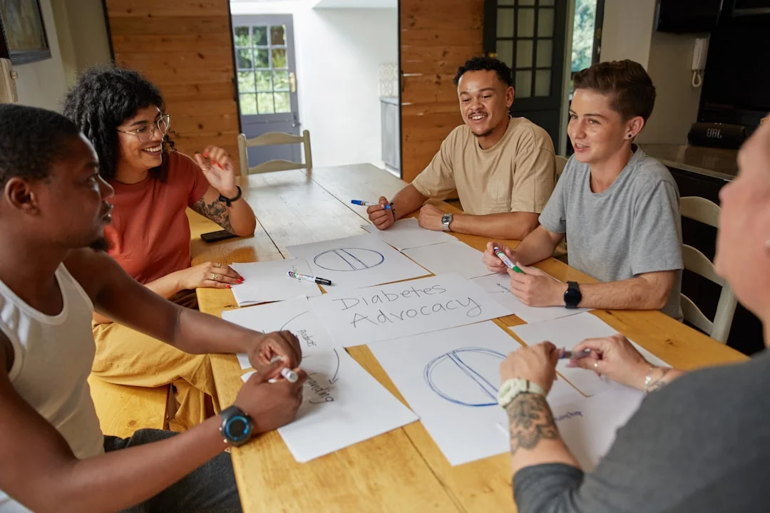 Overhead shot of diverse team analyzing marketing strategies with charts and graphs.
